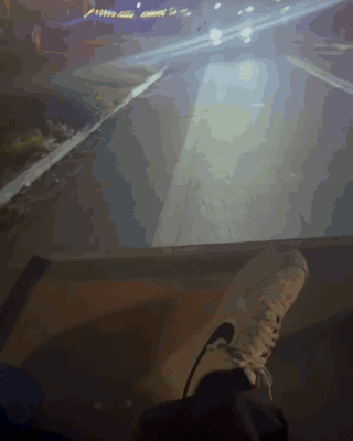 Blurry nighttime footage from the moving truck, streetlights streaking past
